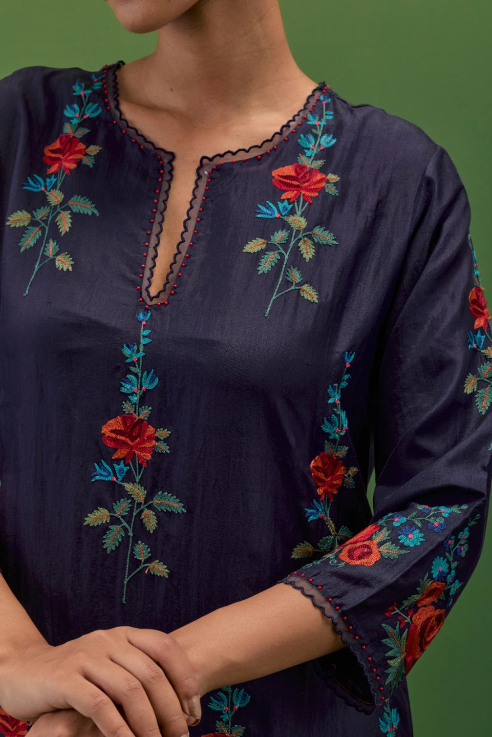 Midnight blue silk straight kurta set with all-over rose embroidery and scalloped organza detail at the edges.