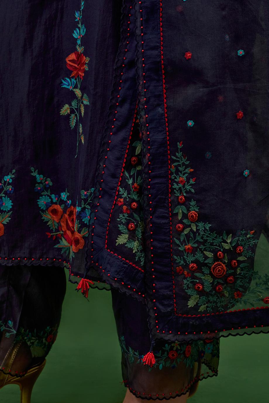 Midnight blue silk straight kurta set with all-over rose embroidery and scalloped organza detail at the edges.