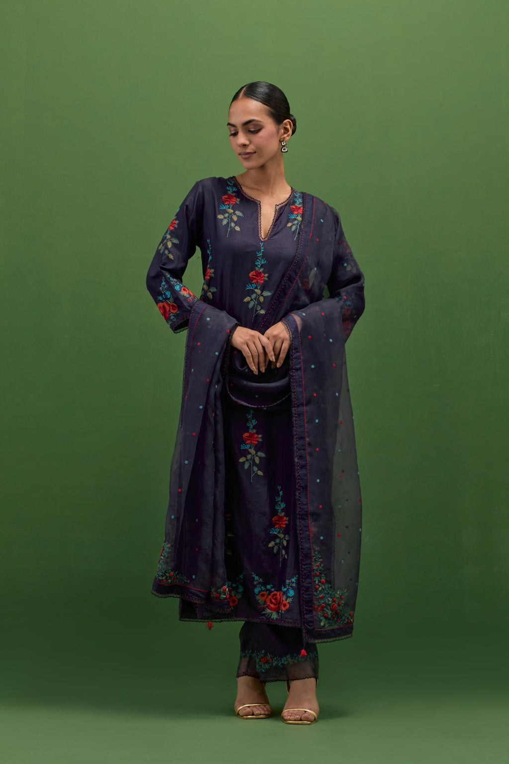 Midnight blue silk straight kurta set with all-over rose embroidery and scalloped organza detail at the edges.