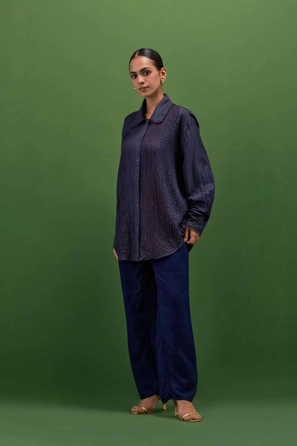 midnigh blue silk shirt with all-over pin tucks, highlighted with contrast beads in the front.