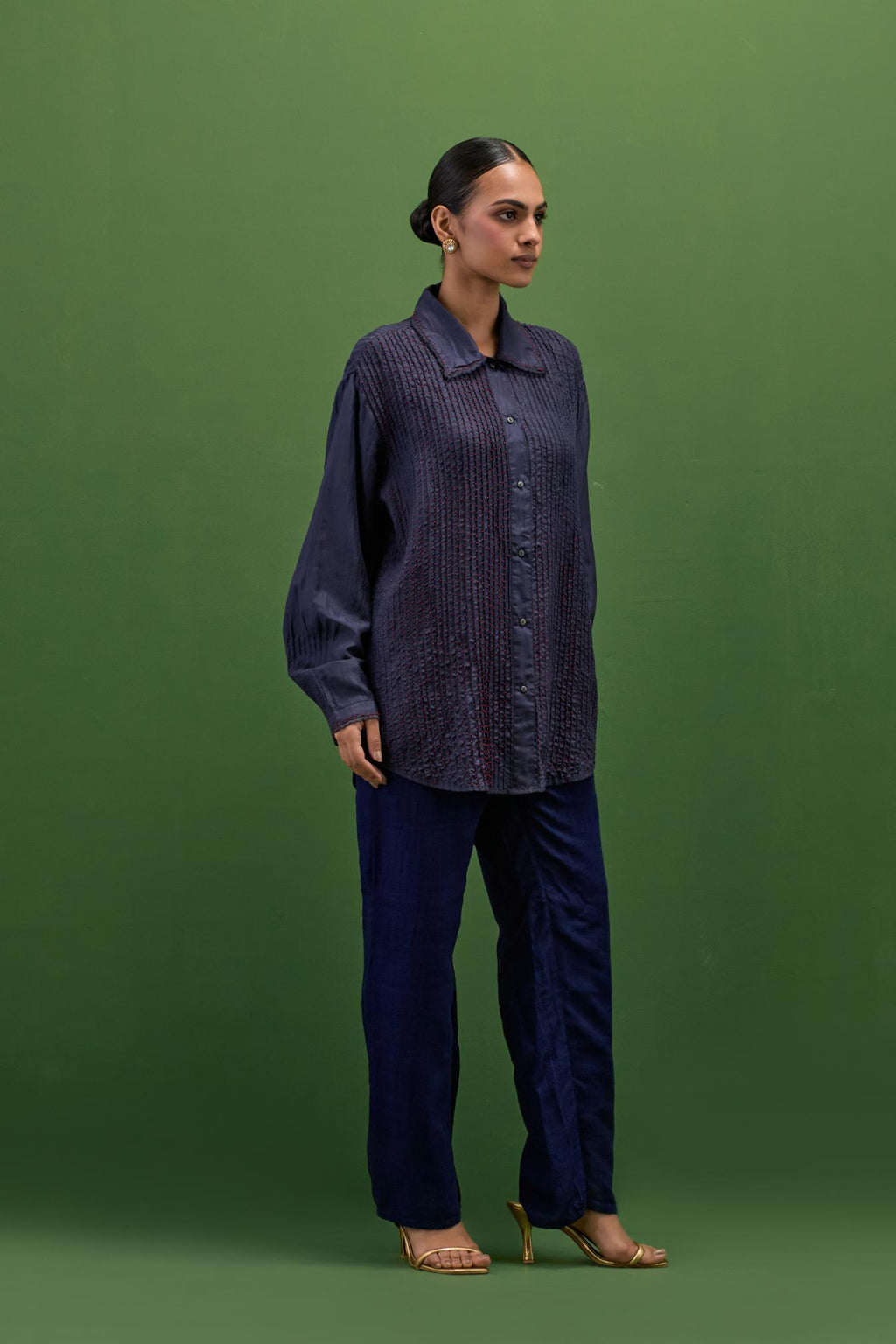 midnigh blue silk shirt with all-over pin tucks, highlighted with contrast beads in the front.