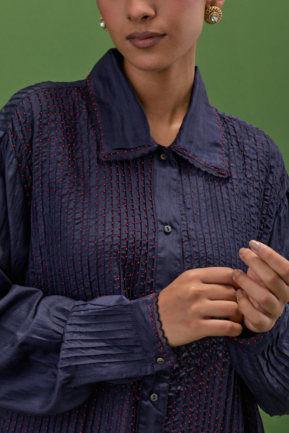 midnigh blue silk shirt with all-over pin tucks, highlighted with contrast beads in the front.