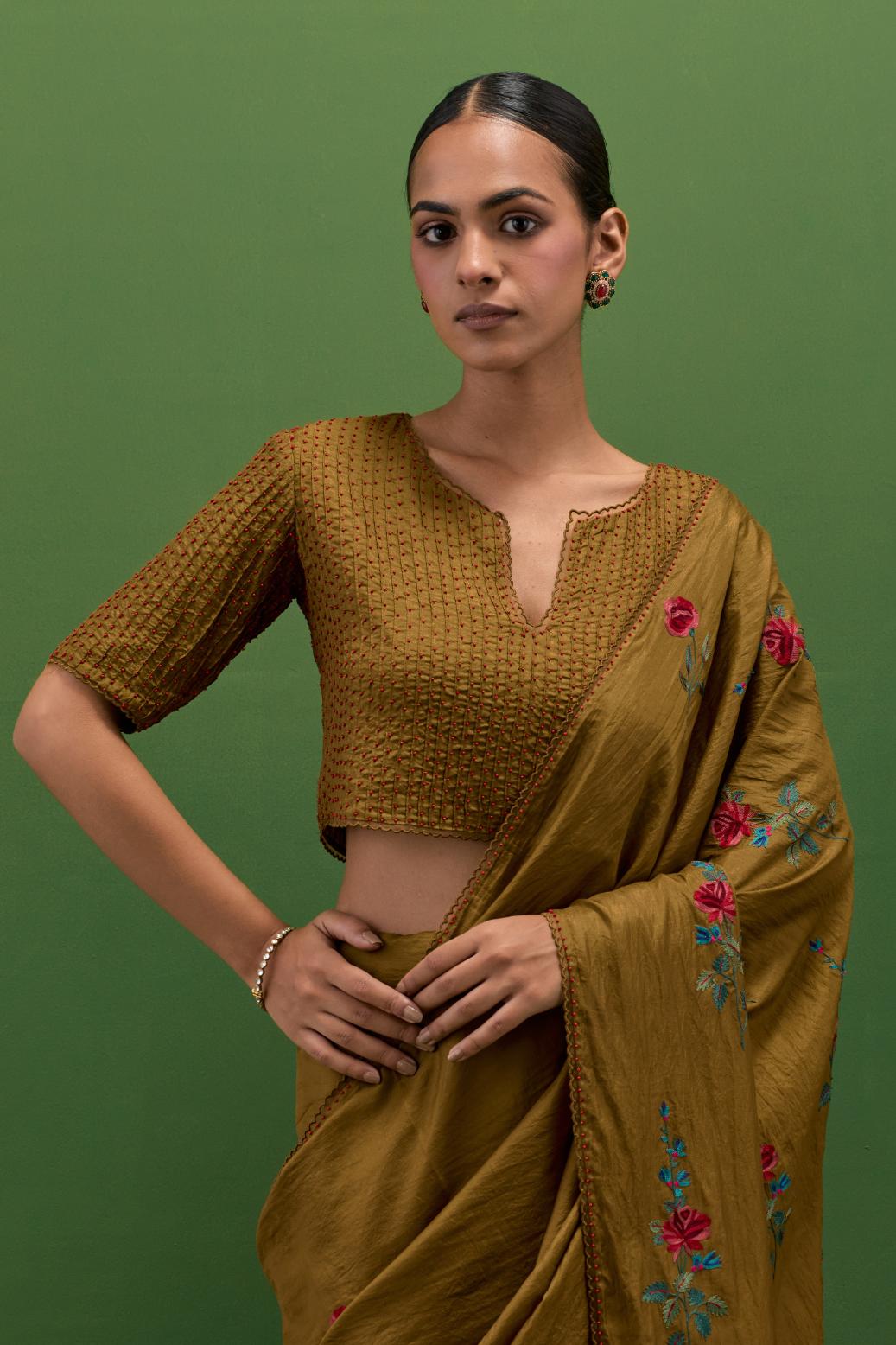 Golden olive silk blouse with all-over pin tucks, highlighted with bead work.