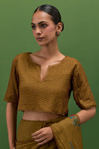 Golden olive silk blouse with all-over pin tucks, highlighted with bead work.