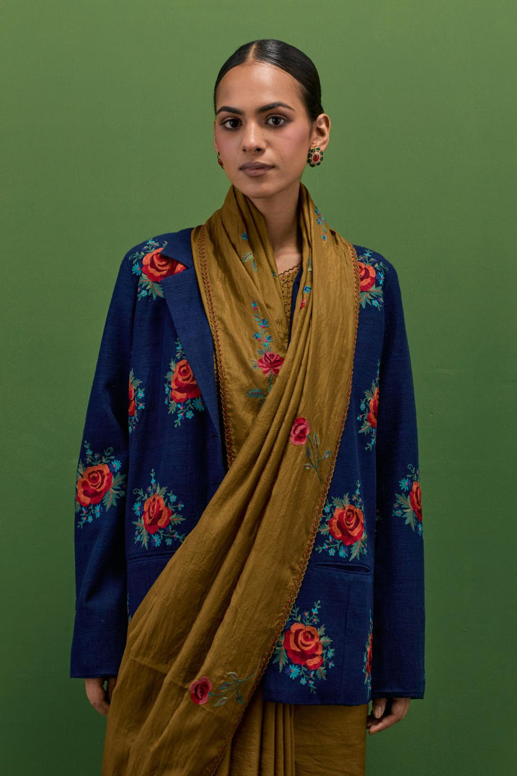 Golden olive silk saree with all-over thread embroidered roses and scalloped organza with delicate bead detail at the edges, paired with golden olive silk blouse with all-over pin tucks, highlighted with bead work.