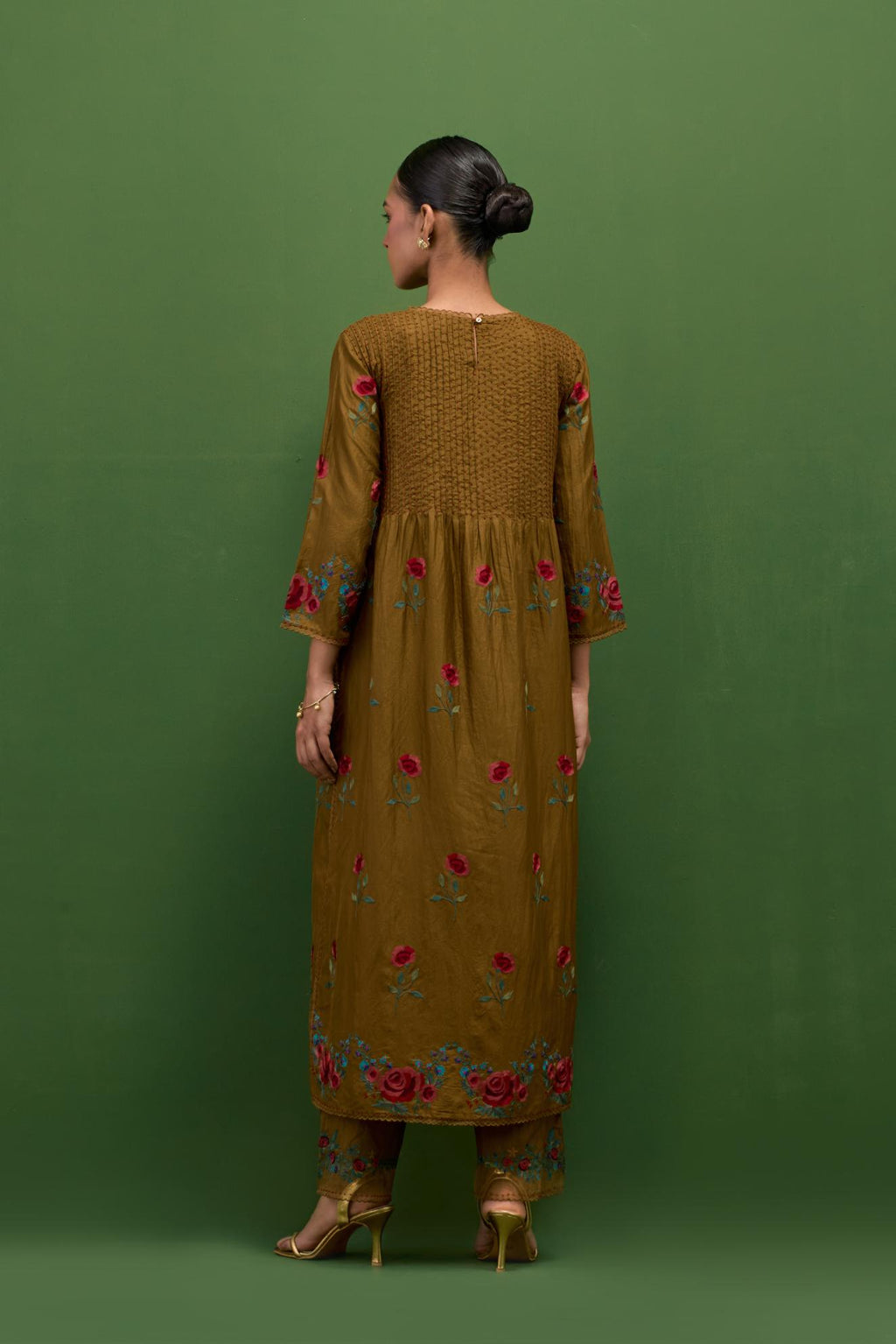 Golden olive silk kurta set with pin tucks at yoke and all-over rose flower embroidery.