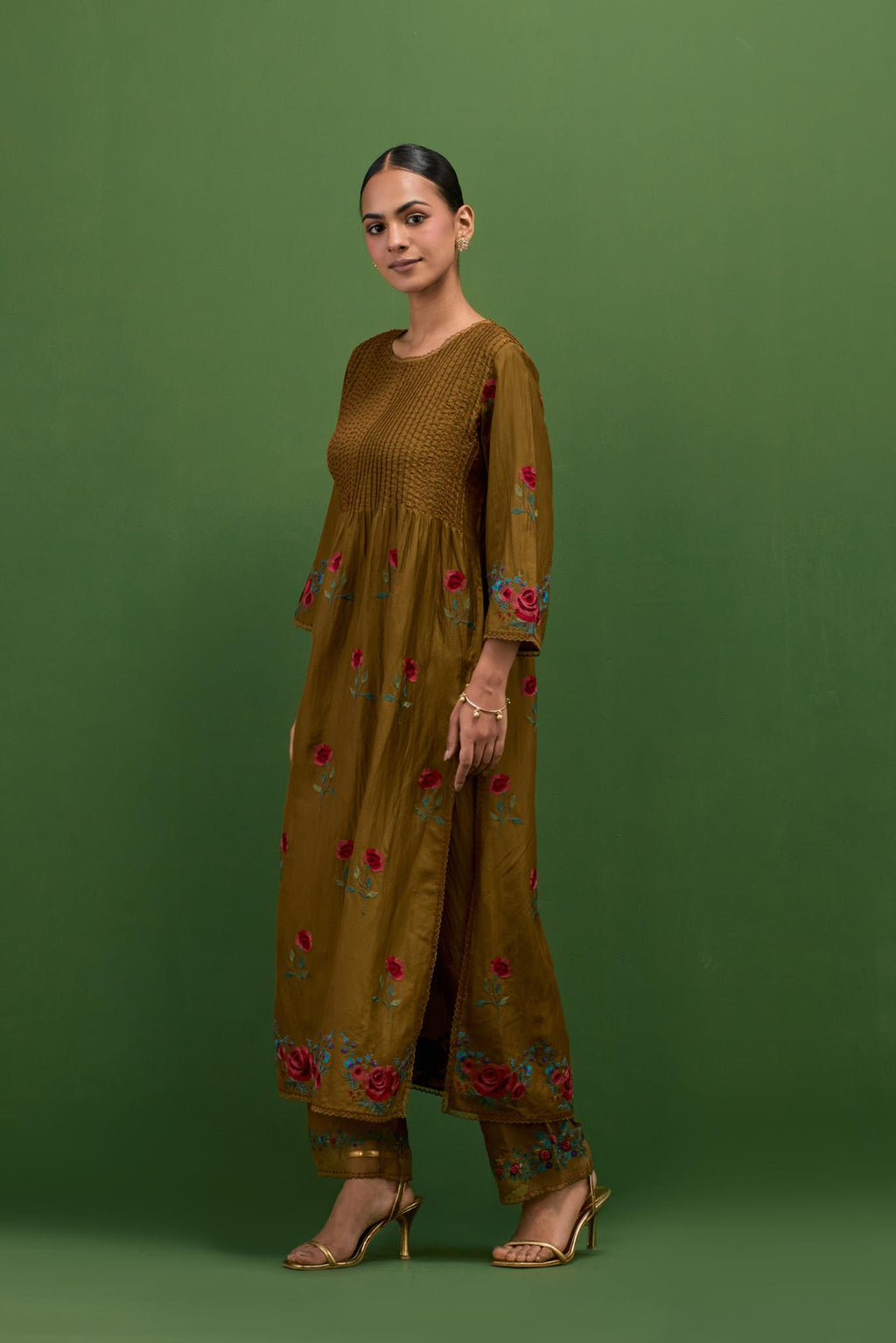 Golden olive silk kurta set with pin tucks at yoke and all-over rose flower embroidery.