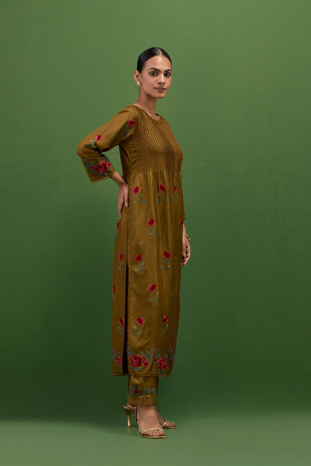 Golden olive silk kurta set with pin tucks at yoke and all-over rose flower embroidery.