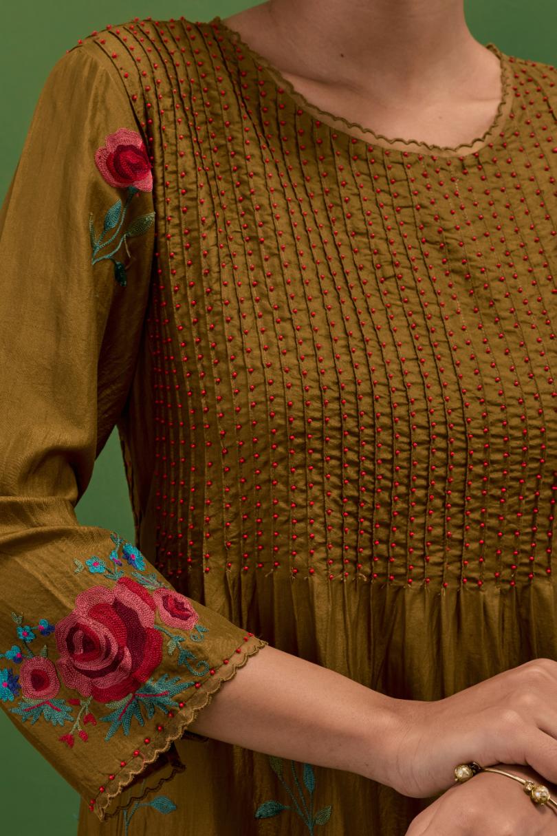 Golden olive silk kurta set with pin tucks at yoke and all-over rose flower embroidery.