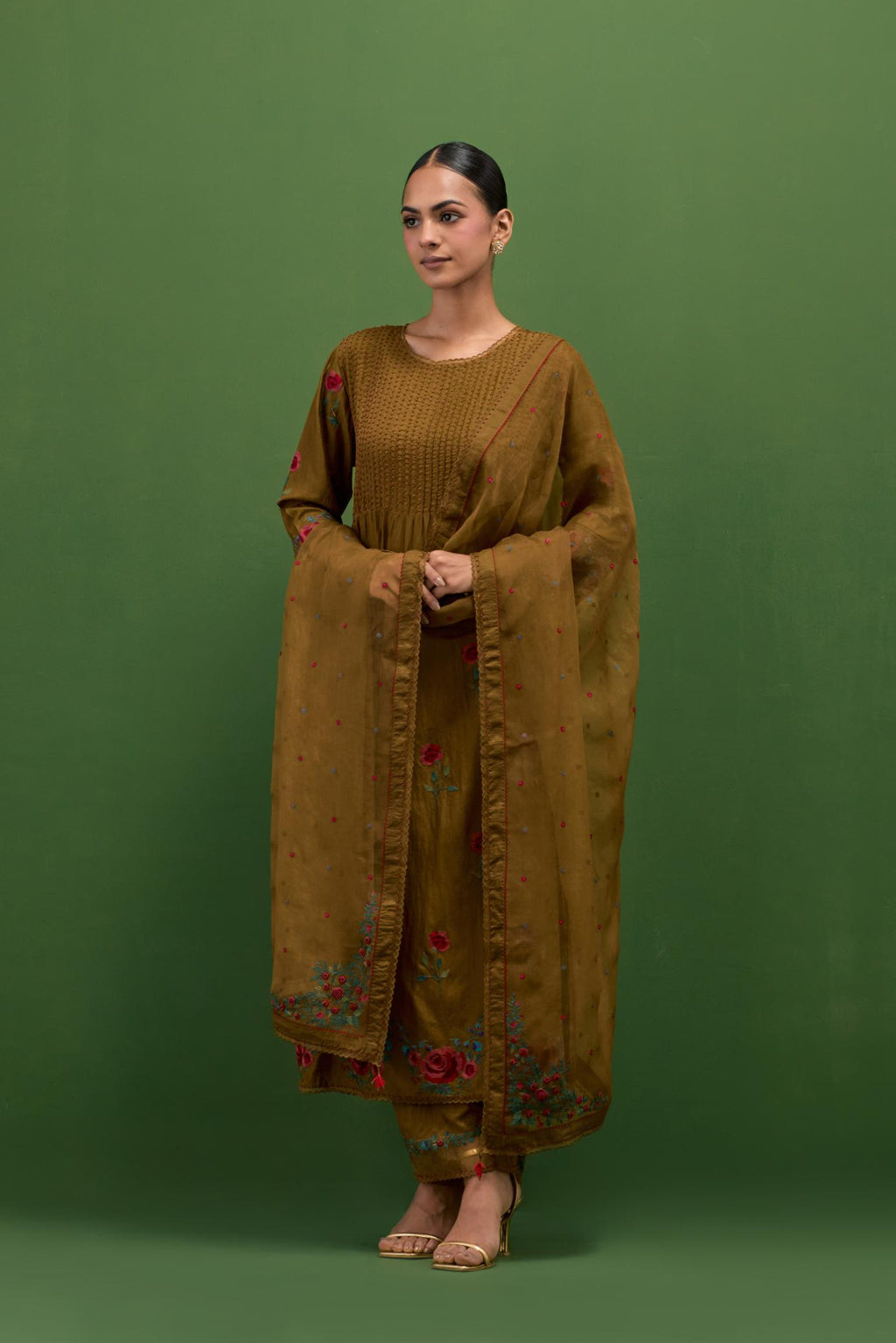 Golden olive silk kurta set with pin tucks at yoke and all-over rose flower embroidery.