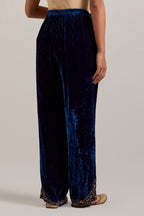 Navy blue Silk velvet pants, highlighted with hand embroidered bead, sequins, zardozi and zari boota at bottom hem.