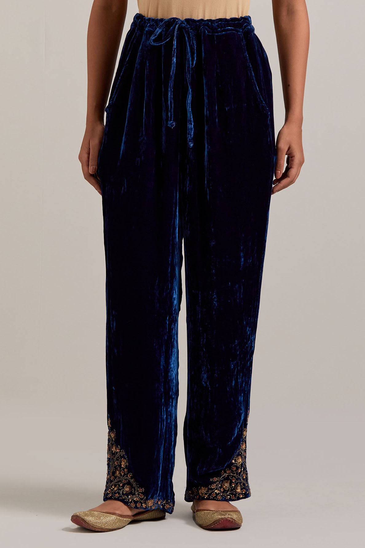 Navy blue Silk velvet pants, highlighted with hand embroidered bead, sequins, zardozi and zari boota at bottom hem.