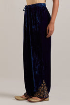 Navy blue Silk velvet pants, highlighted with hand embroidered bead, sequins, zardozi and zari boota at bottom hem.