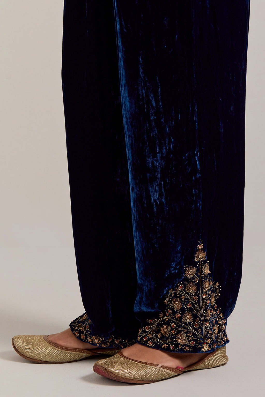 Navy blue Silk velvet pants, highlighted with hand embroidered bead, sequins, zardozi and zari boota at bottom hem.