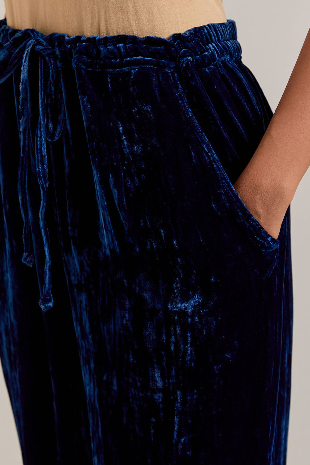 Navy blue Silk velvet pants, highlighted with hand embroidered bead, sequins, zardozi and zari boota at bottom hem.