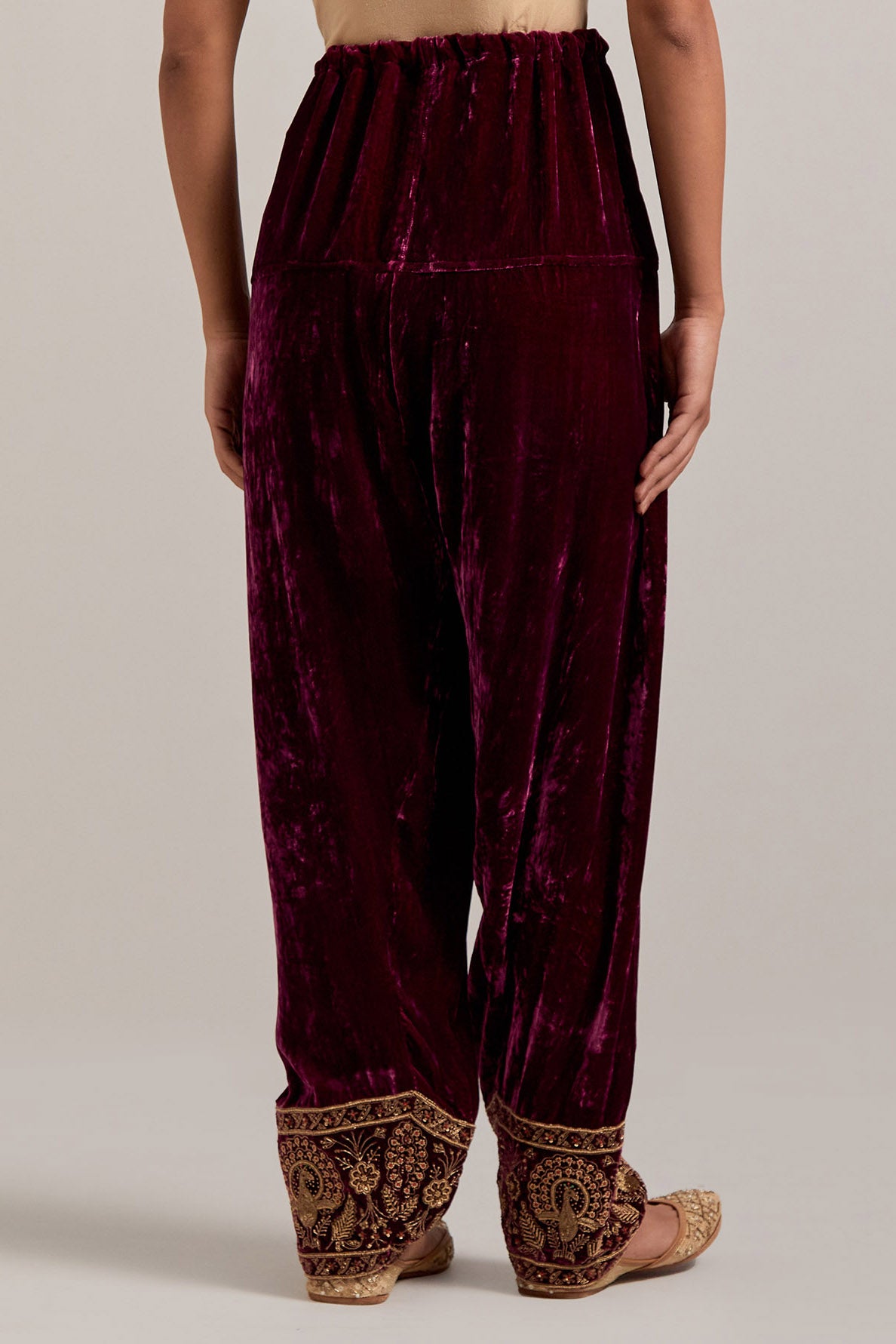 Plum Silk velvet salwar, highlighted with hand embroidered bead, sequins, zardozi and zari border at bottom hem.