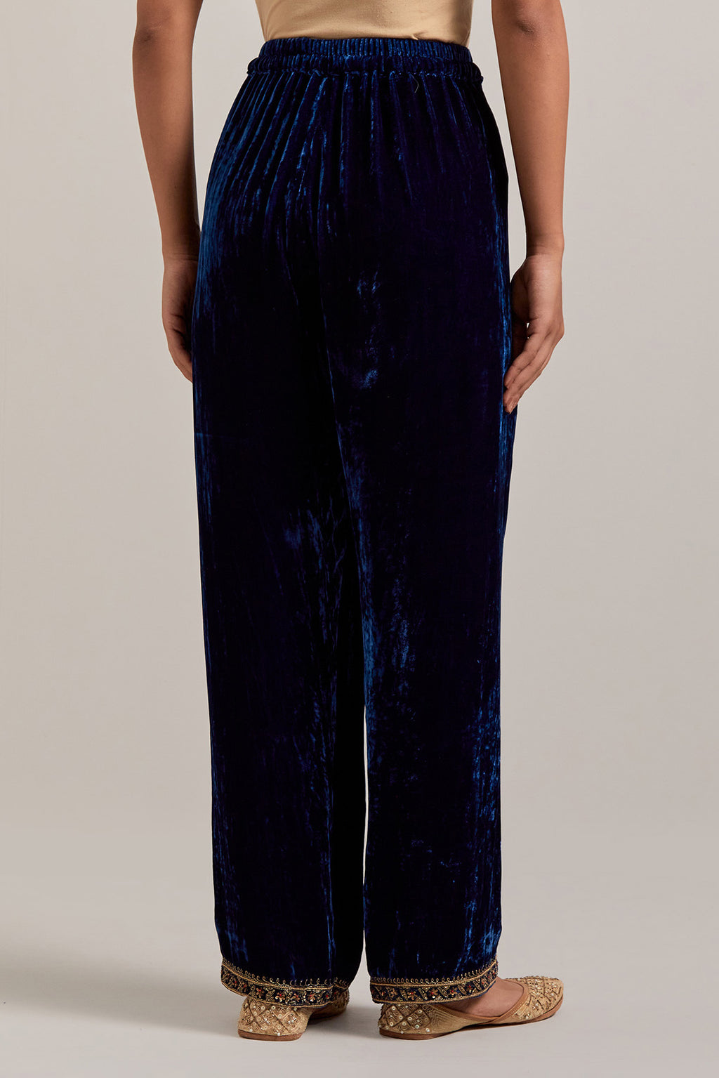 Navy blue Silk velvet pants, highlighted with hand embroidered bead, sequins, zardozi and zari narrow border at bottom hem.