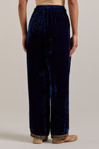 Navy blue Silk velvet pants, highlighted with hand embroidered bead, sequins, zardozi and zari narrow border at bottom hem.