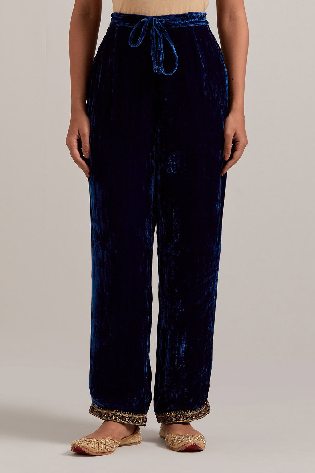 Navy blue Silk velvet pants, highlighted with hand embroidered bead, sequins, zardozi and zari narrow border at bottom hem.