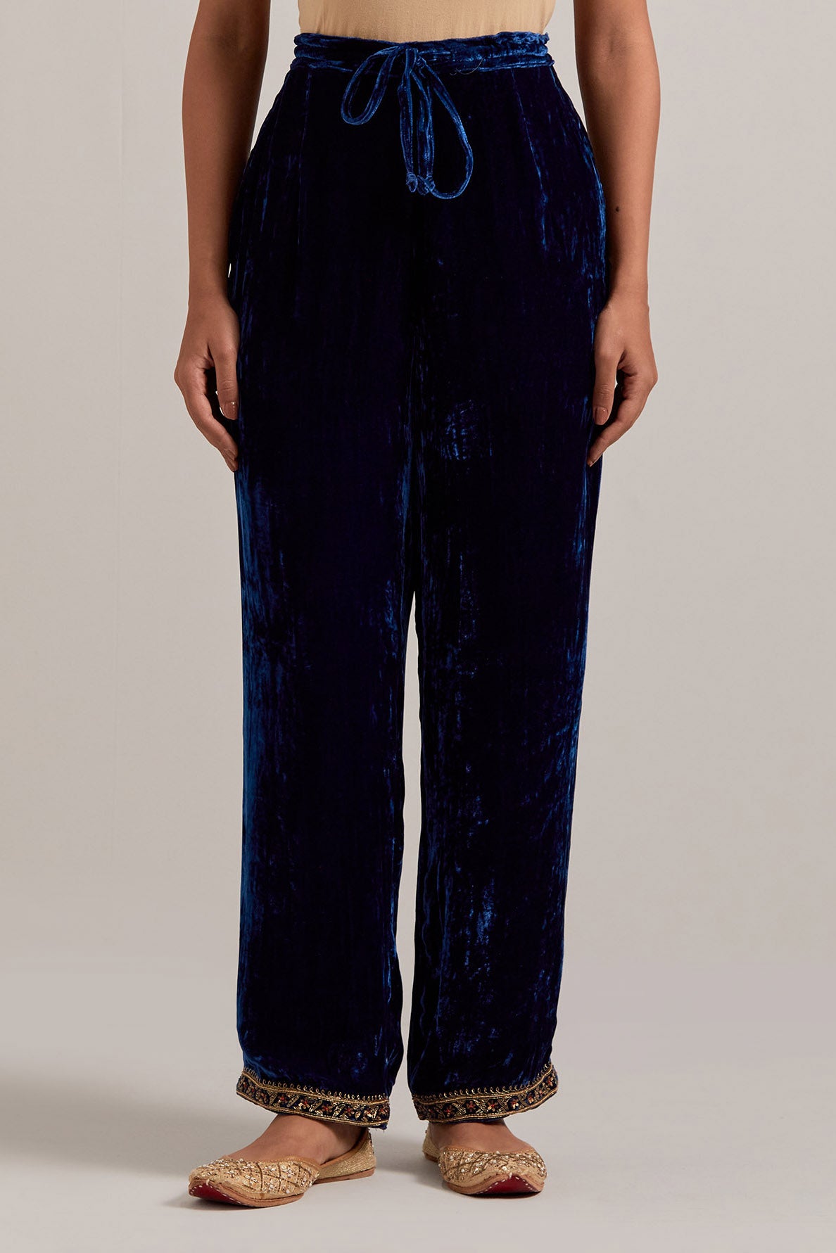 Navy blue Silk velvet pants, highlighted with hand embroidered bead, sequins, zardozi and zari narrow border at bottom hem.
