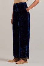 Navy blue Silk velvet pants, highlighted with hand embroidered bead, sequins, zardozi and zari narrow border at bottom hem.