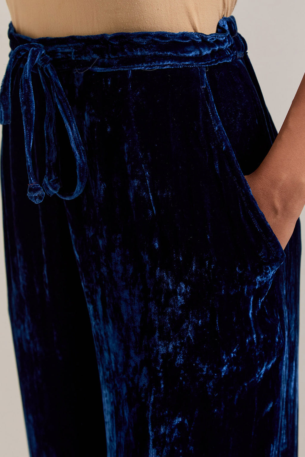 Navy blue Silk velvet pants, highlighted with hand embroidered bead, sequins, zardozi and zari narrow border at bottom hem.