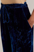 Navy blue Silk velvet pants, highlighted with hand embroidered bead, sequins, zardozi and zari narrow border at bottom hem.