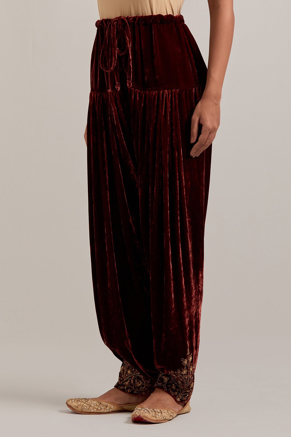 Burnt umber Silk velvet salwar, highlighted with hand embroidered bead, sequins, zardozi and zari boota at bottom hem.