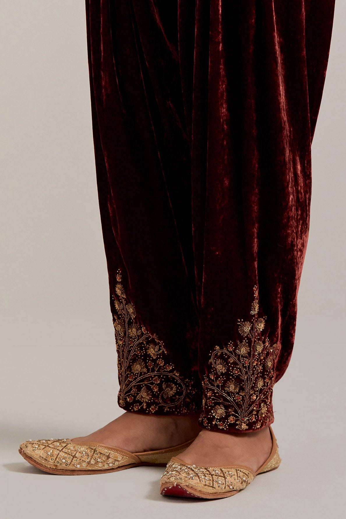 Burnt umber Silk velvet salwar, highlighted with hand embroidered bead, sequins, zardozi and zari boota at bottom hem.
