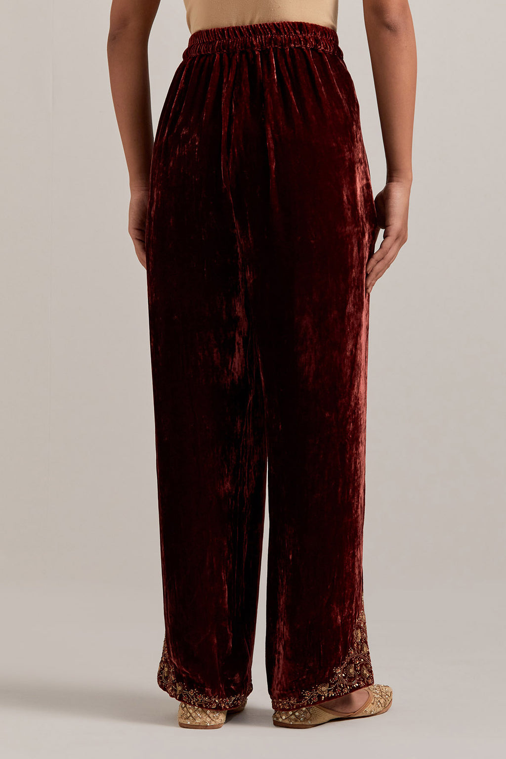 Burnt umber Silk velvet pants, highlighted with hand embroidered bead, sequins, zardozi and zari boota at bottom hem.