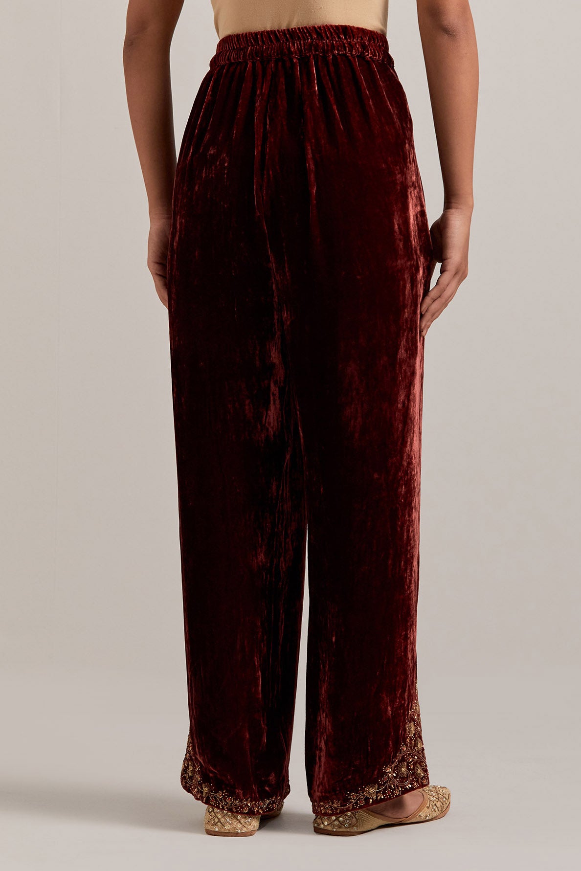 Burnt umber Silk velvet pants, highlighted with hand embroidered bead, sequins, zardozi and zari boota at bottom hem.