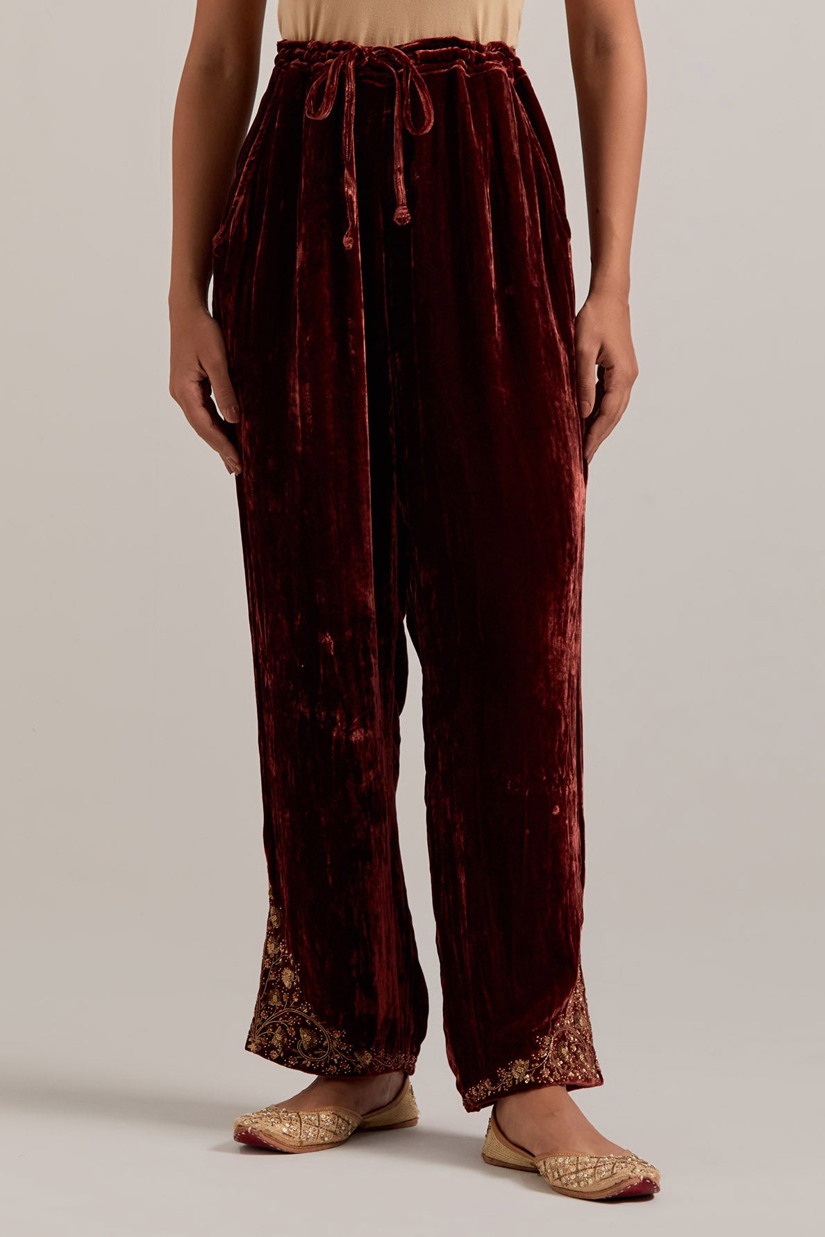 Burnt umber Silk velvet pants, highlighted with hand embroidered bead, sequins, zardozi and zari boota at bottom hem.