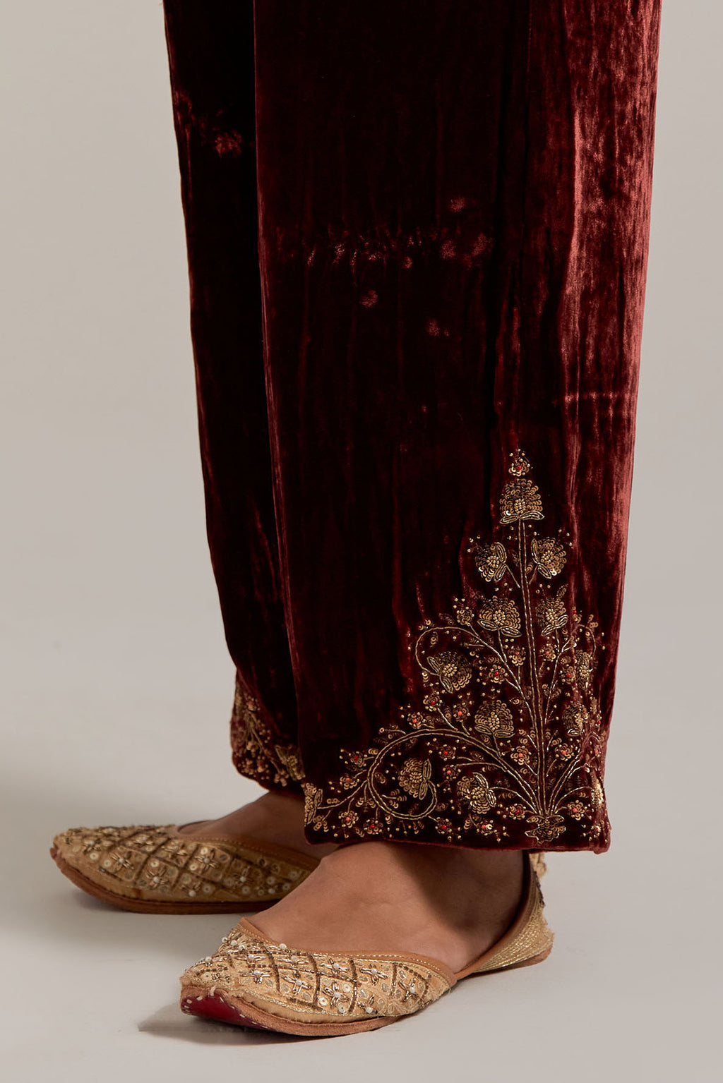 Burnt umber Silk velvet pants, highlighted with hand embroidered bead, sequins, zardozi and zari boota at bottom hem.