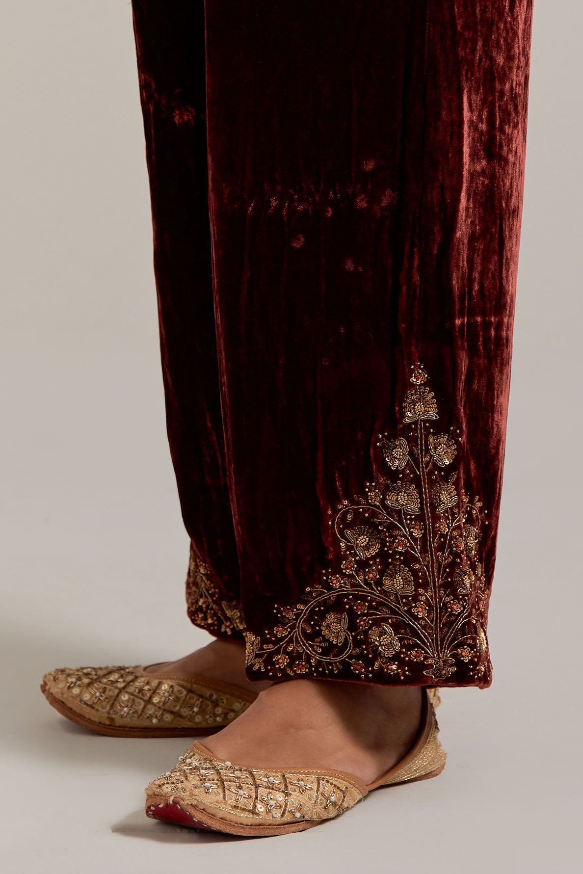 Burnt umber Silk velvet pants, highlighted with hand embroidered bead, sequins, zardozi and zari boota at bottom hem.
