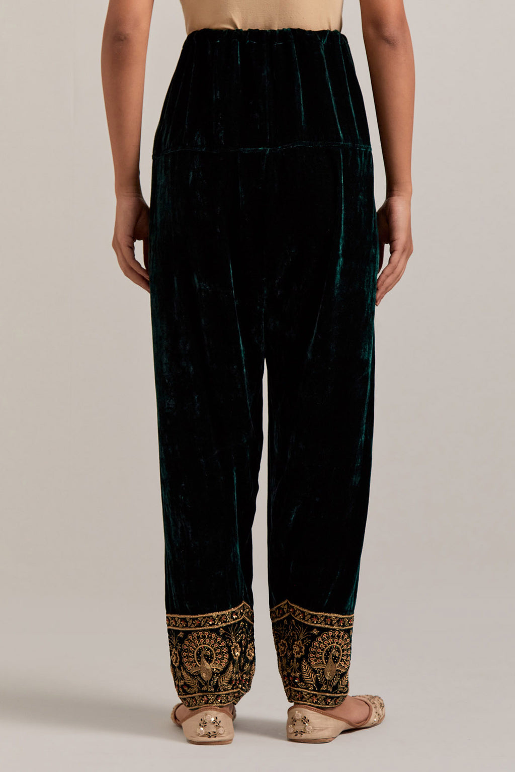 Dark green Silk velvet salwar, highlighted with hand embroidered bead, sequins, zardozi and zari border at bottom hem.