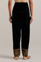 Dark green Silk velvet salwar, highlighted with hand embroidered bead, sequins, zardozi and zari border at bottom hem.