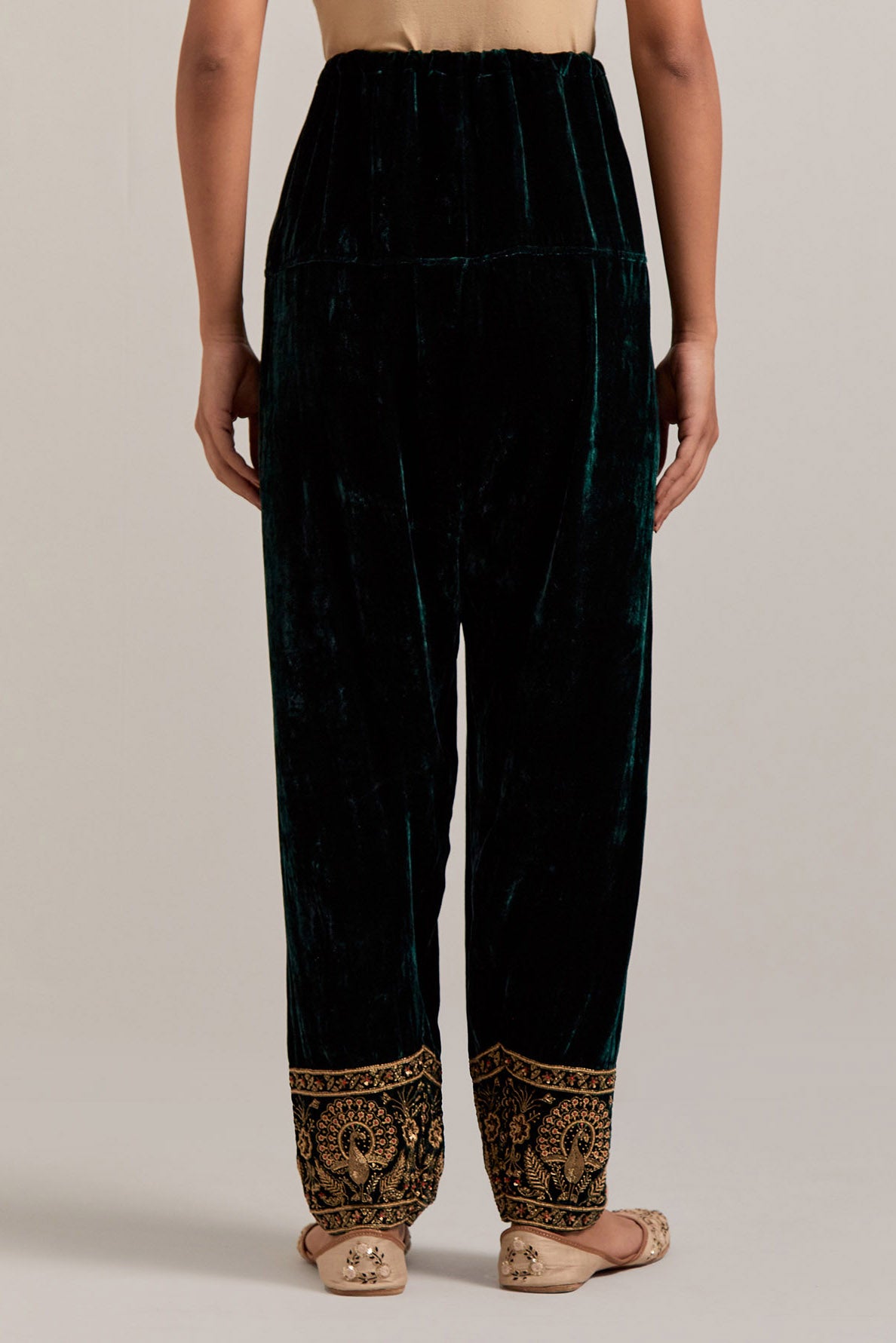 Dark green Silk velvet salwar, highlighted with hand embroidered bead, sequins, zardozi and zari border at bottom hem.