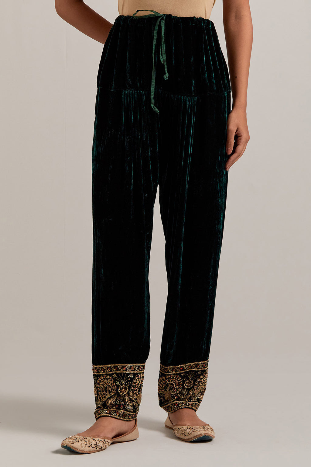 Dark green Silk velvet salwar, highlighted with hand embroidered bead, sequins, zardozi and zari border at bottom hem.