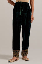 Dark green Silk velvet salwar, highlighted with hand embroidered bead, sequins, zardozi and zari border at bottom hem.