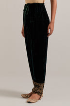 Dark green Silk velvet salwar, highlighted with hand embroidered bead, sequins, zardozi and zari border at bottom hem.