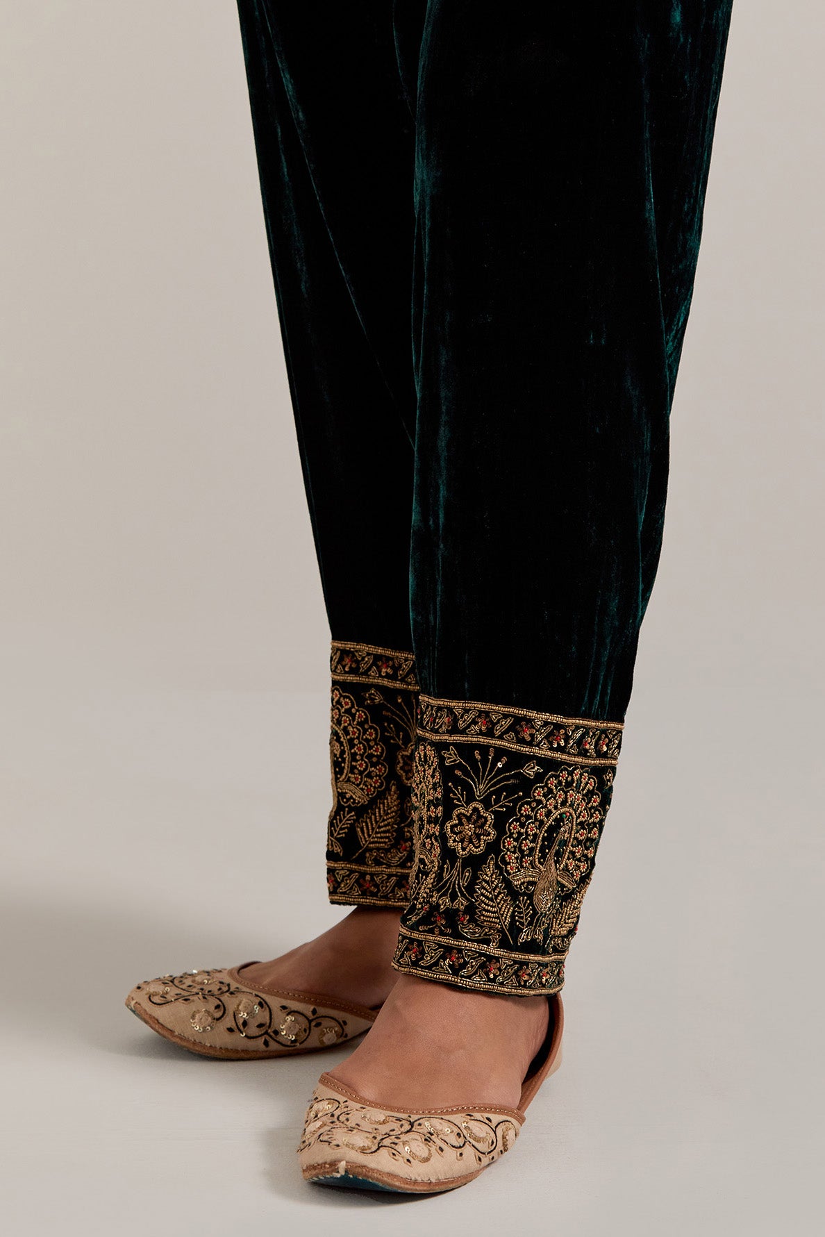 Dark green Silk velvet salwar, highlighted with hand embroidered bead, sequins, zardozi and zari border at bottom hem.