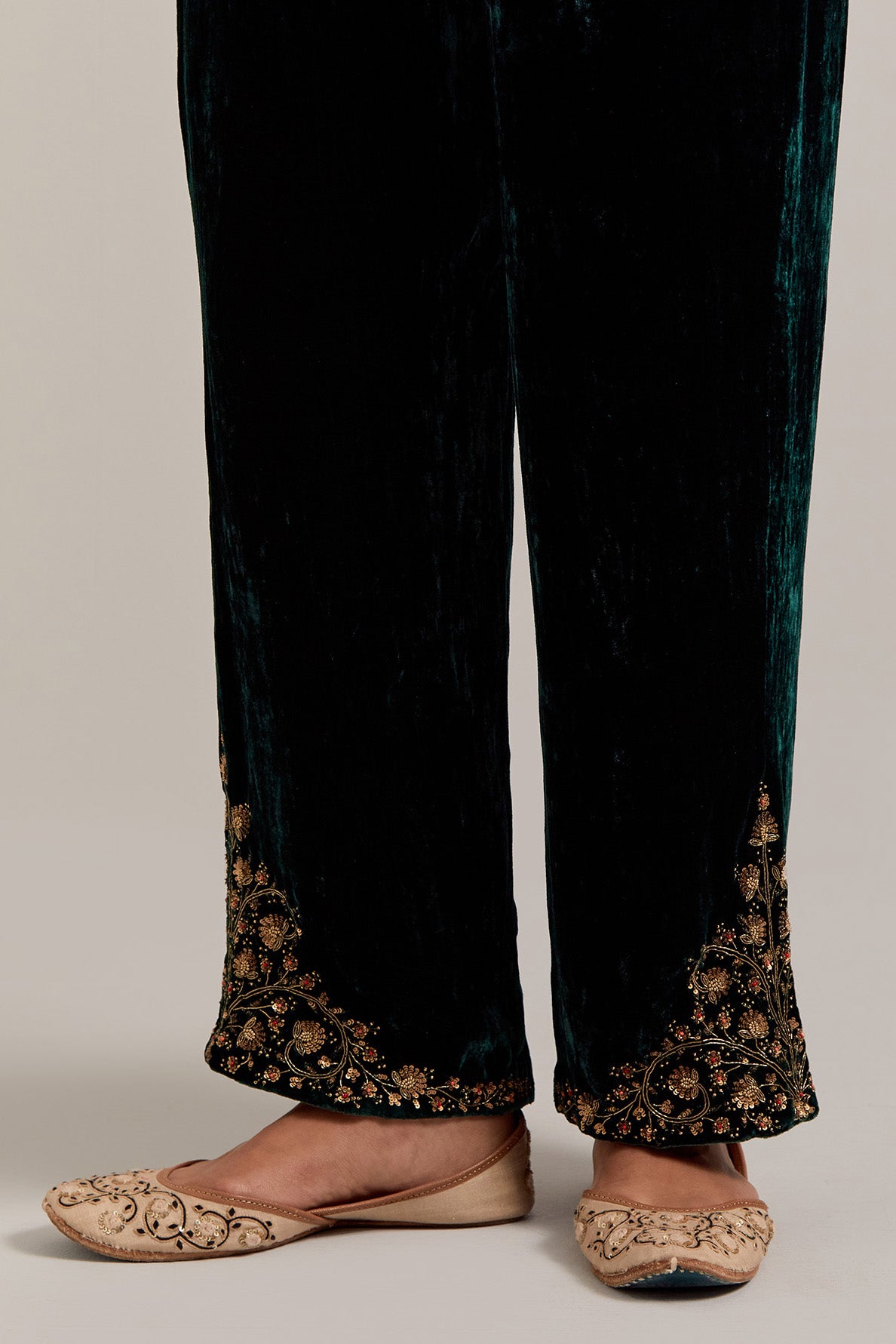 Dark green Silk velvet pants, highlighted with hand embroidered bead, sequins, zardozi and zari boota at bottom hem.