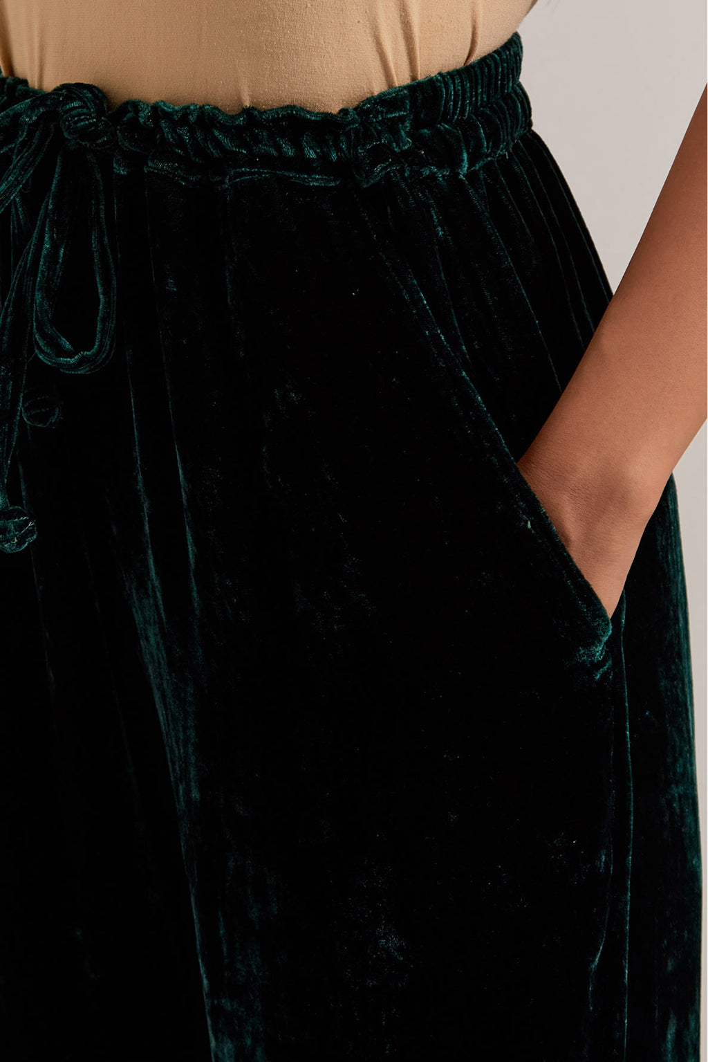 Dark green Silk velvet salwar, highlighted with hand embroidered bead, sequins, zardozi and zari border at bottom hem.
