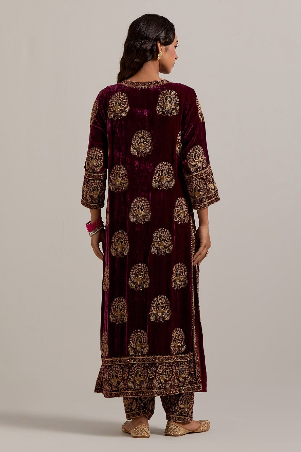 Plum silk velvet straight kurta set with sequins, zardozi, zari embroidered peacock boota all-over the kurta, highlighted with contrast bead work.