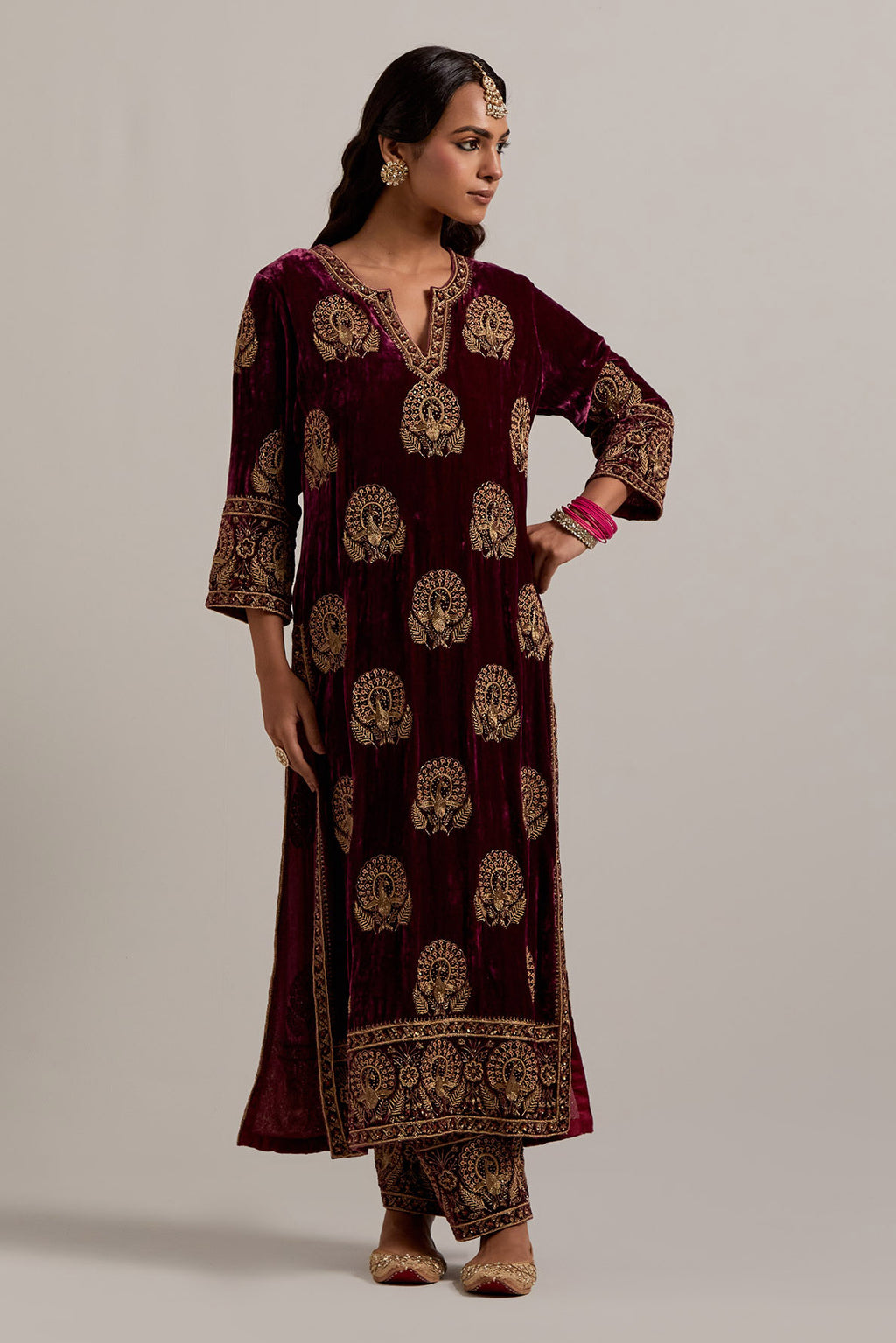 Plum silk velvet straight kurta set with sequins, zardozi, zari embroidered peacock boota all-over the kurta, highlighted with contrast bead work.