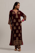 Plum silk velvet straight kurta set with sequins, zardozi, zari embroidered peacock boota all-over the kurta, highlighted with contrast bead work.