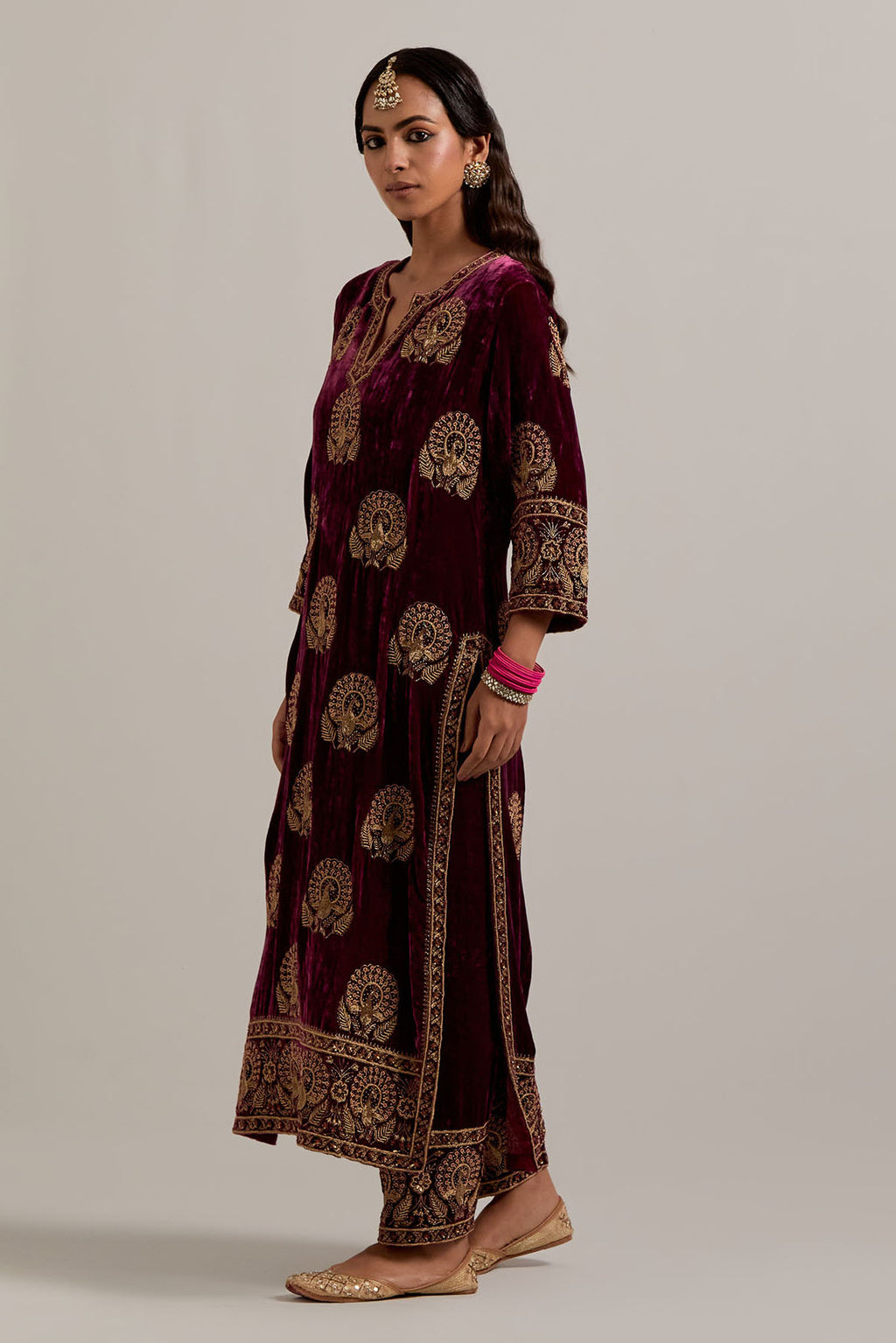 Plum silk velvet straight kurta set with sequins, zardozi, zari embroidered peacock boota all-over the kurta, highlighted with contrast bead work.
