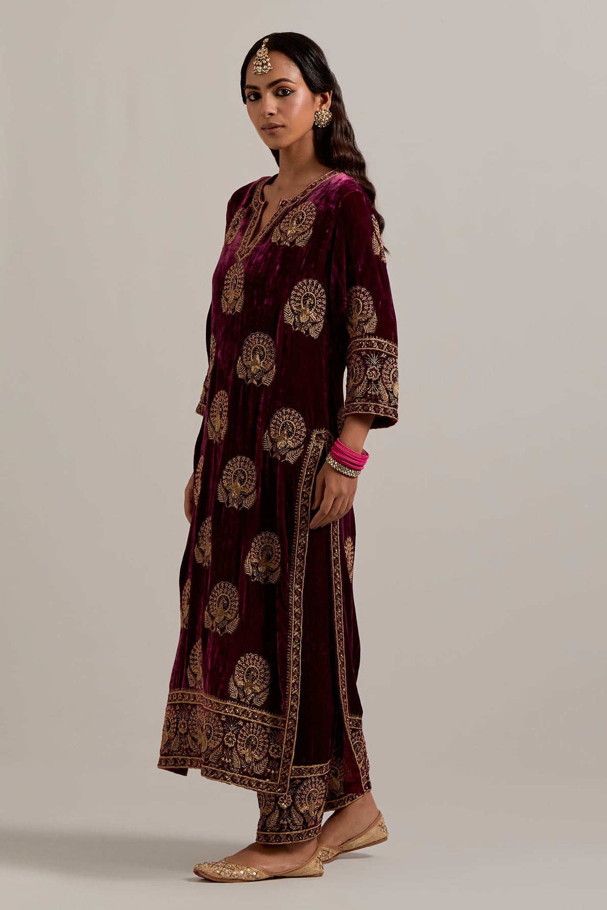 Plum silk velvet straight kurta set with sequins, zardozi, zari embroidered peacock boota all-over the kurta, highlighted with contrast bead work.