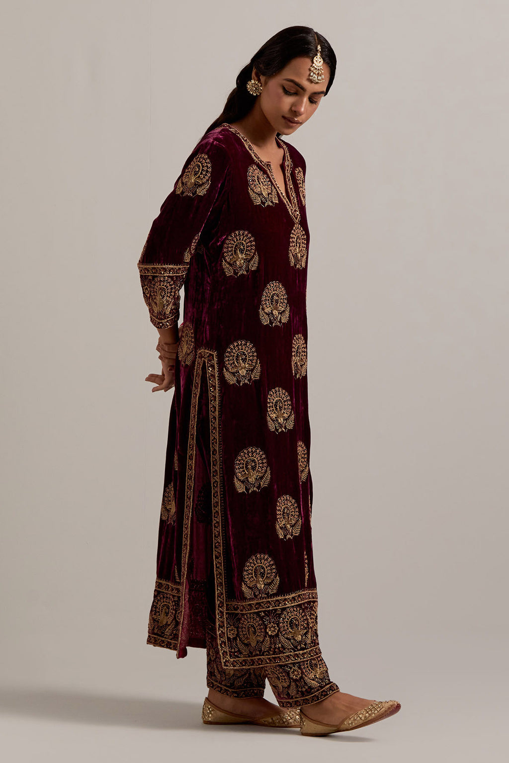 Plum silk velvet straight kurta set with sequins, zardozi, zari embroidered peacock boota all-over the kurta, highlighted with contrast bead work.