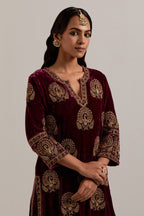 Plum silk velvet straight kurta set with sequins, zardozi, zari embroidered peacock boota all-over the kurta, highlighted with contrast bead work.